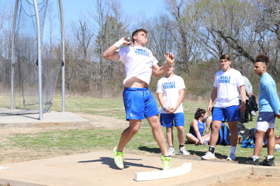 Sophomore Casey Poe throws during a shot put competition.