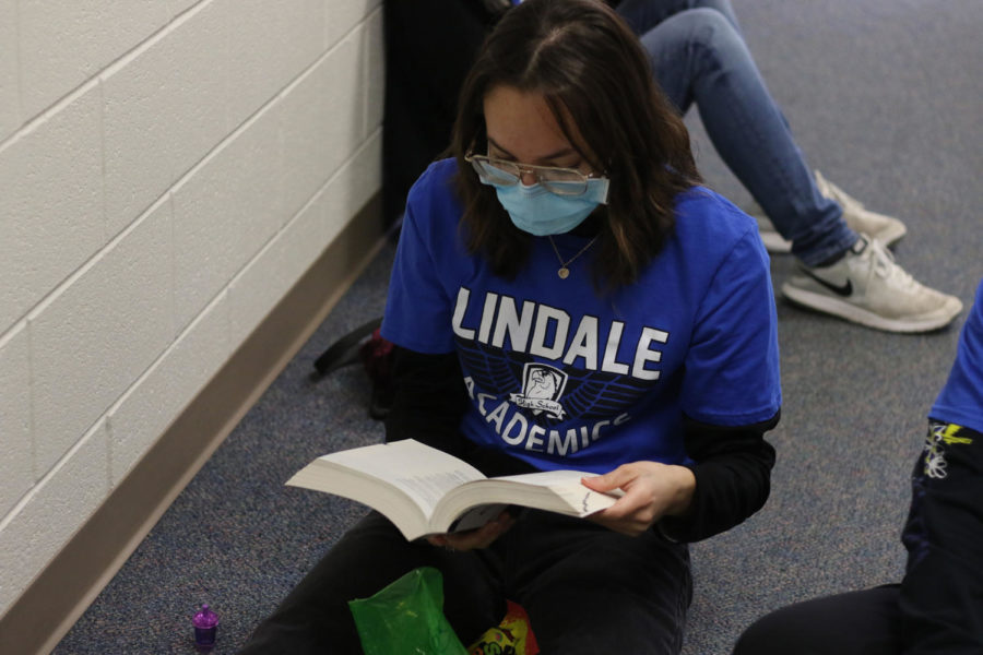 Senior Jesika Miller studies the AP style guide at the Lindale meet. This book is mainly used for the copy editing contest.