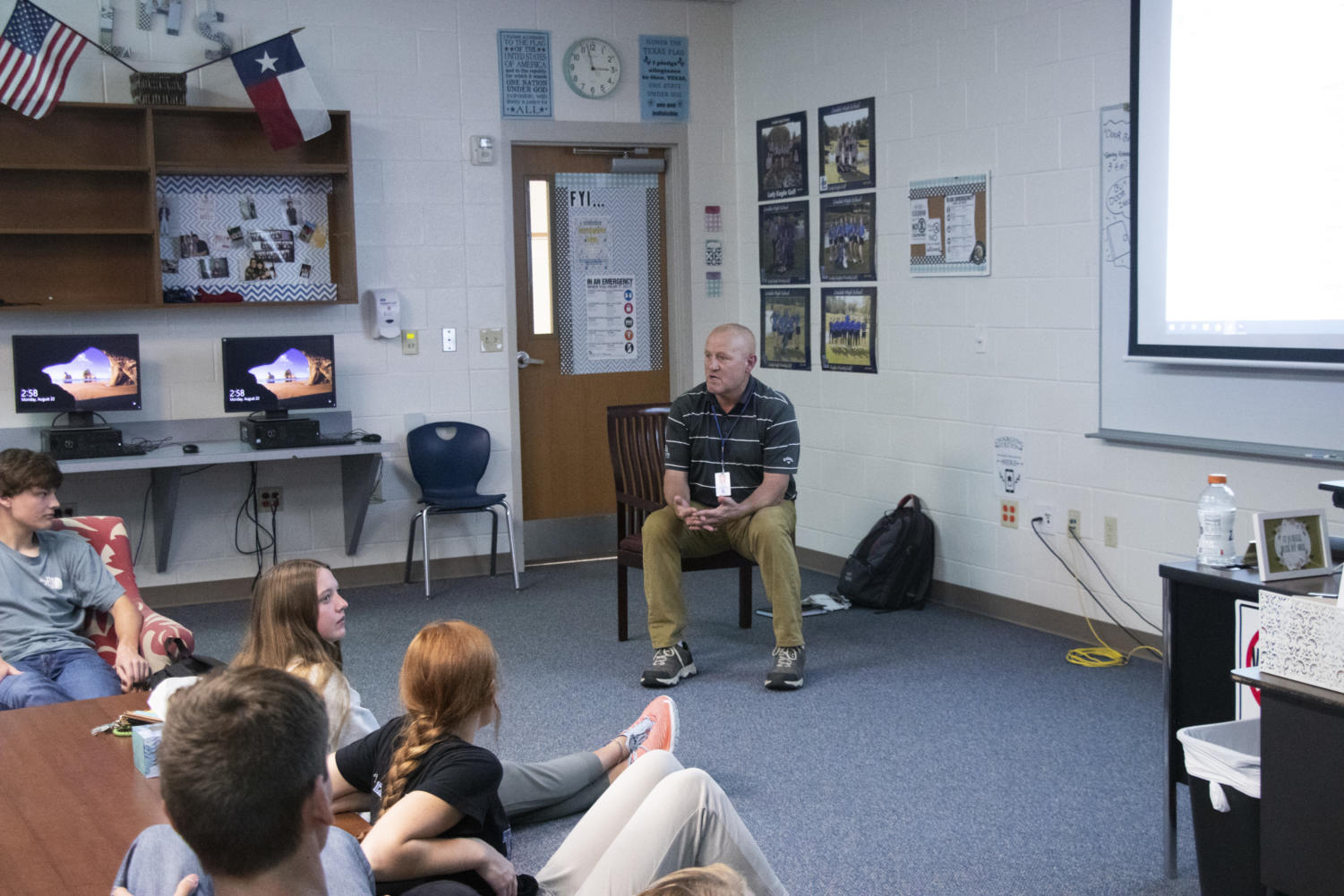 Coach Temple teaches his students new golf techniques in a discussion session at the start of school.