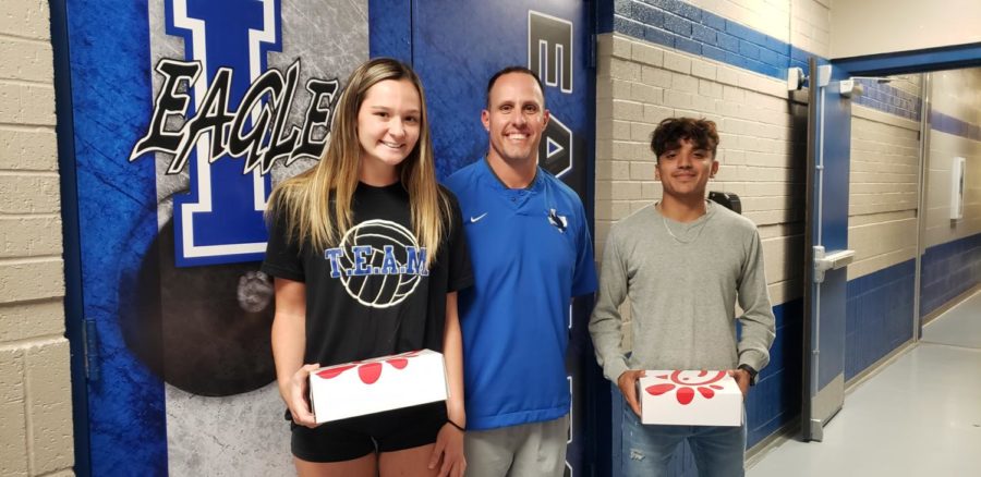 Athletic+Director+Chris+Cochran+presents+seniors+Alex+Gutierrez+and+Brooke+Tweedell+with+Chick+fil+A+lunches+for+being+named+the+September+Athletes+of+the+Month.