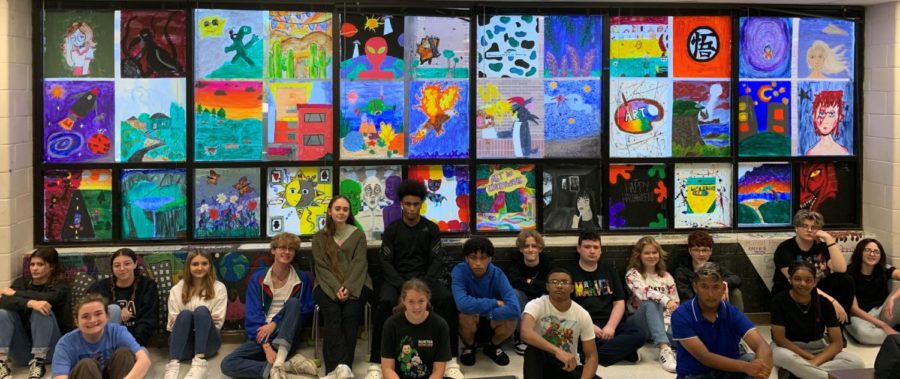 Sixth period art students pose in front of their art murals. This project was such a fun but challenging experience, junior Ireland Cornejo said. 


