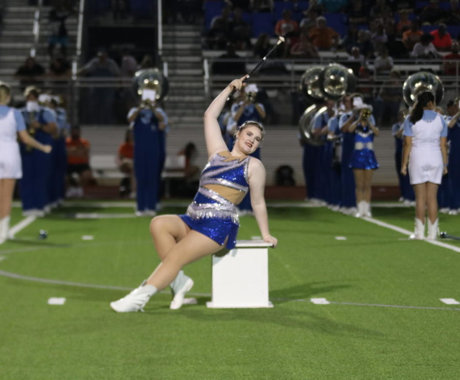 Senior Elanna Perkins performs a twirl dance routine to Runaway Baby during halftime at a football game. I love performing under the friday night lights, Perkins said.