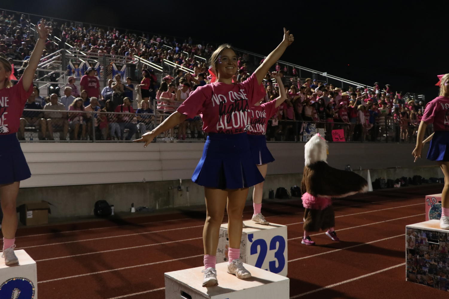 Sophomore Rylee Ford cheers on the football team at the pink out game.