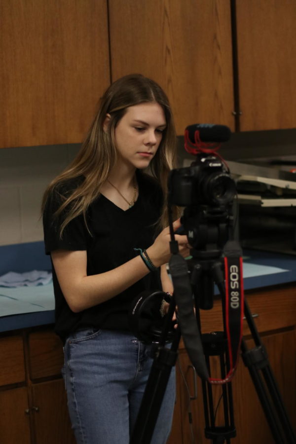Sophomore+Bailey+Park+adjusts+her+camera.+She+was+helping+film+the+Print+Shop+documentary