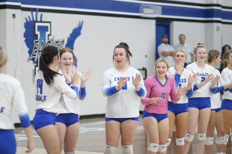 Senior Keatyn Bills cheers on her teammates at a varsity volleyball game.