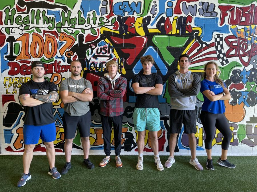 Students pose at Fusion Athletic Club with owners and staff. “I have learned that every business is completely different,” senior Cannon Terry said. “There is not a single business that operates the exact same.”