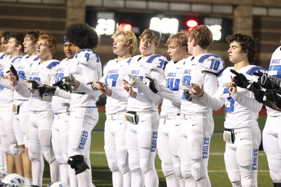 The varsity football boys singing the school song at the end of a football game. They lost to Kilgore in the playoffs, ending their football season.