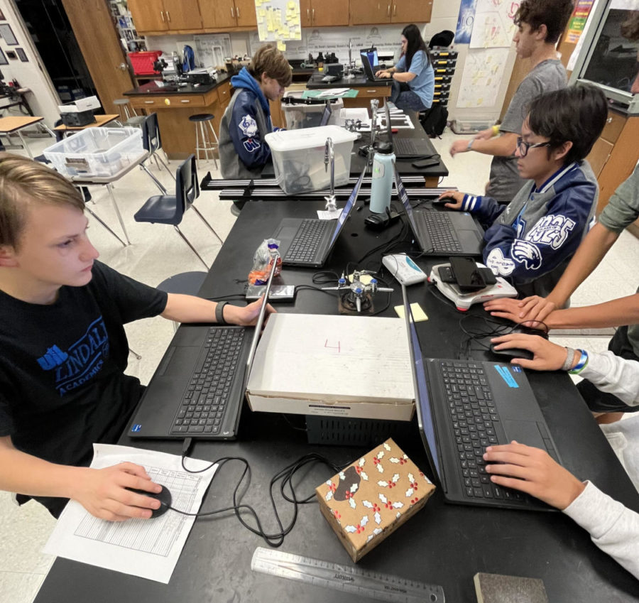 The team hard at work. "The team prepares by showing up to practices," robotics sponsor Duane Walton said. "They put in a lot of time to get these things ready."