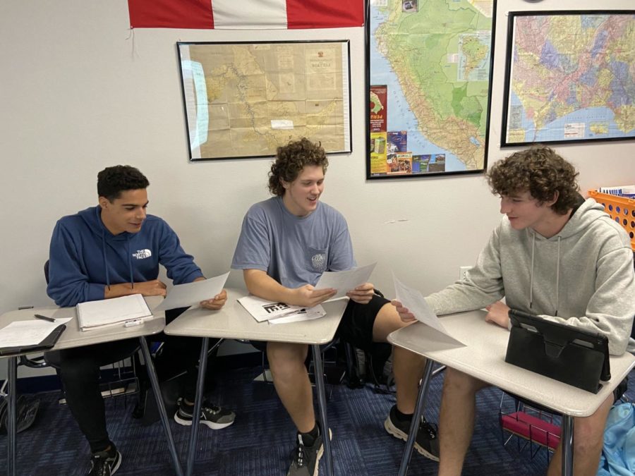 Juniors Henrique Arantes, Cole Williams, and Kaden Strickland practice their carols in Spanish II. The students will go class to class to perform their carols on Friday