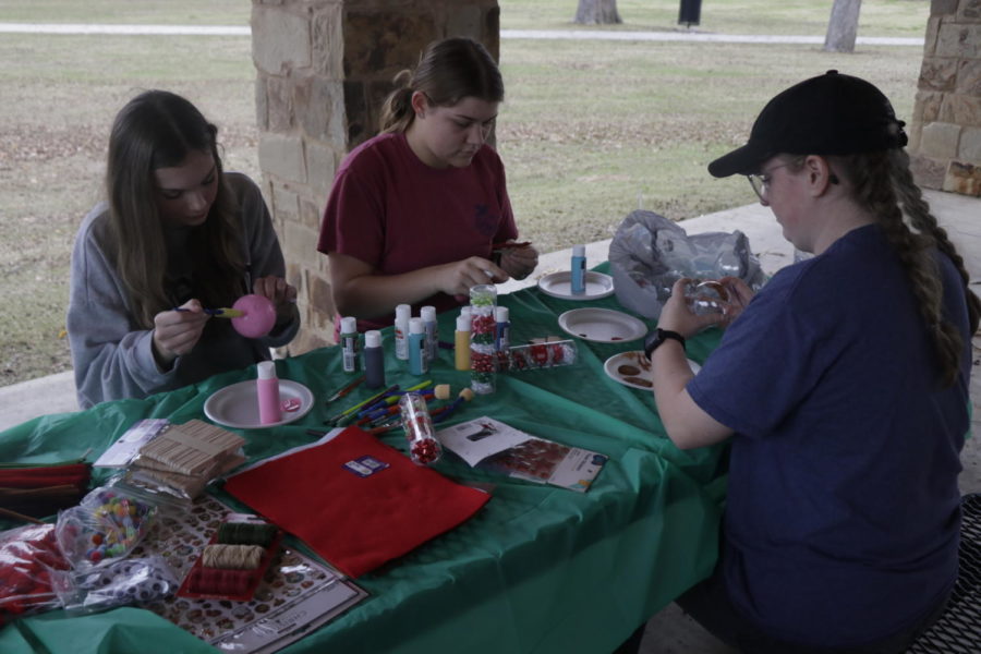 Key Club students decorate ornamments at the park.