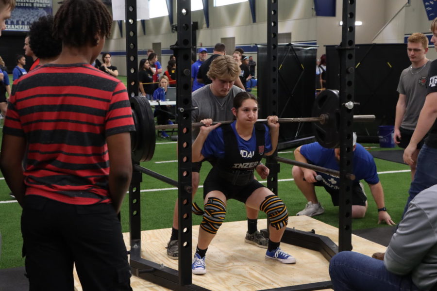 The girls powerlifting team competes in a home meet.