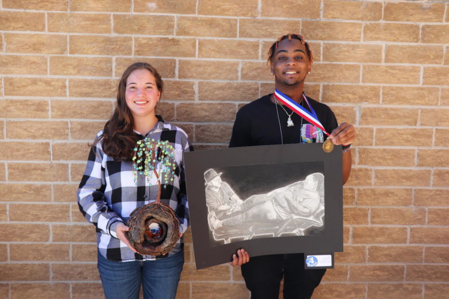 Junior+Laura+Watters+and+senior+Jaden+Roquemore+pose+with+their+art+pieces.+They+both+competed+at+State+VASE.
