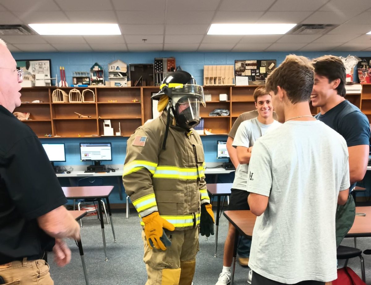 A student wears the entirety of the firefighter suit except the gas tank. The gas tank needs another set of skills to put on safely and correctly. 
Photo Courtesy of Teri Hodges