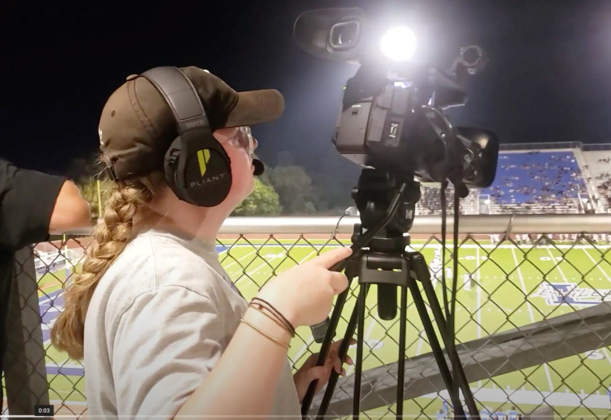 Junior Kylie Gorman livestreams the Kaufman game from the third deck of the press box.  