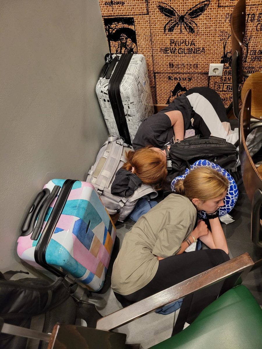 Sophomore Josey Derosier and freshman Morgan Myrick sleep in the airport before a 12 hour flight. This was the last day in Europe.