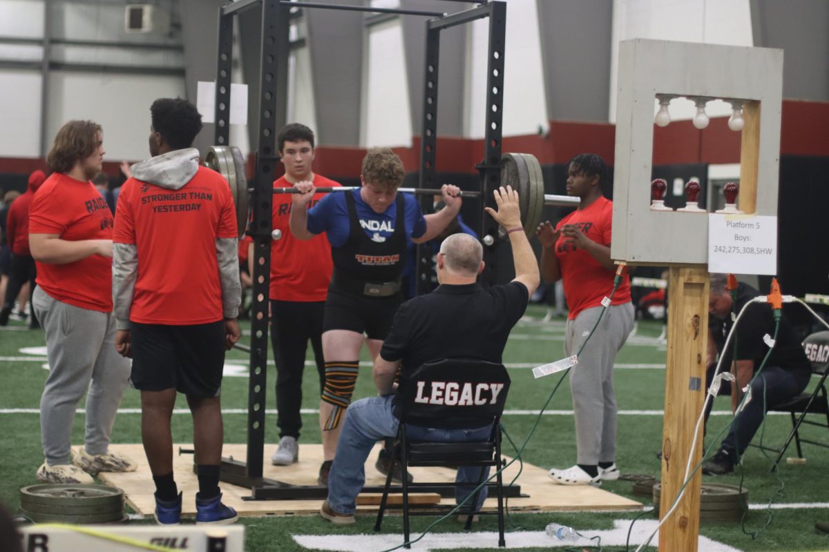 Drew Ragland about to squat at last season’s meet at Legacy high school. "My favorite part about meets are hitting new PRs and watching my teammates hit PRs as well."