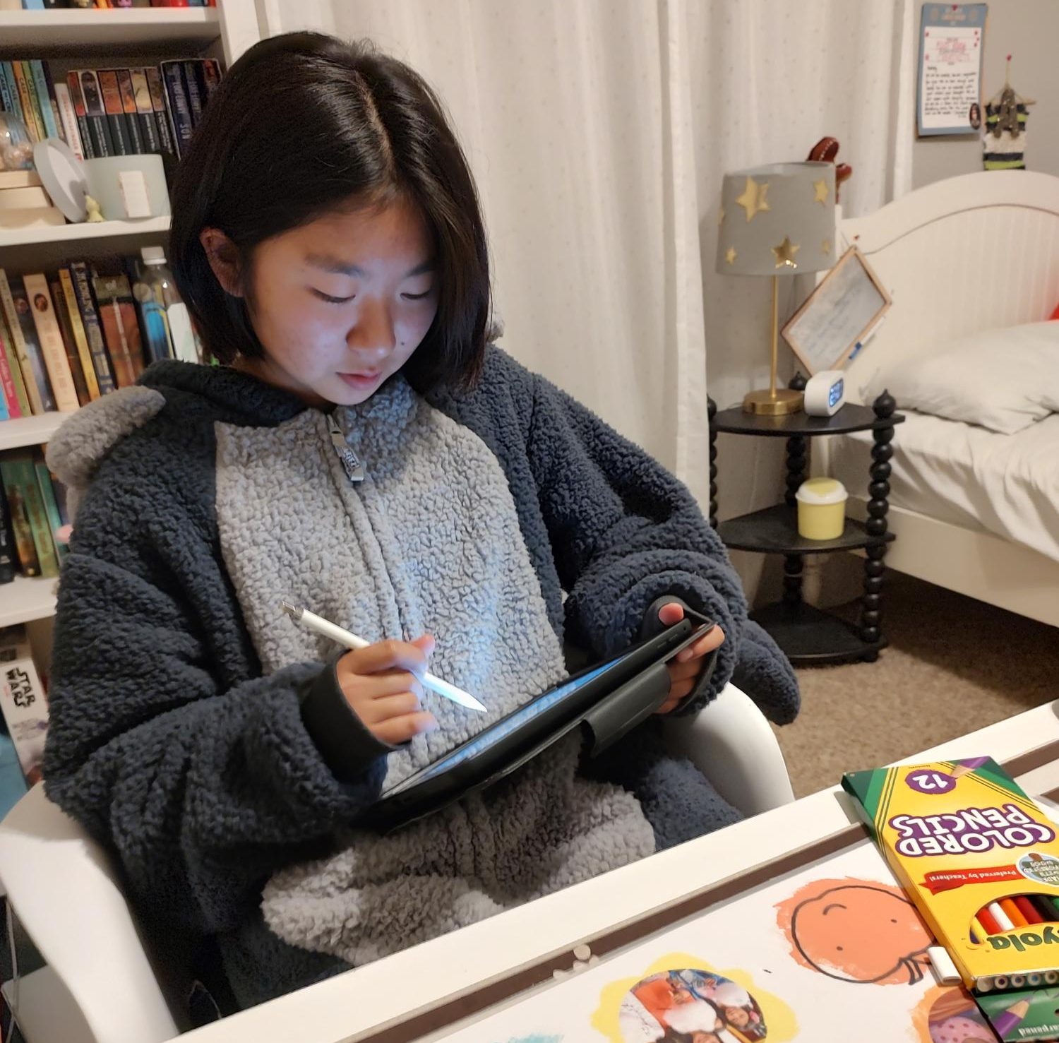 Sophomore Audrey Yang works on an art commission. She uses a tablet and digital pen for most of her pieces.