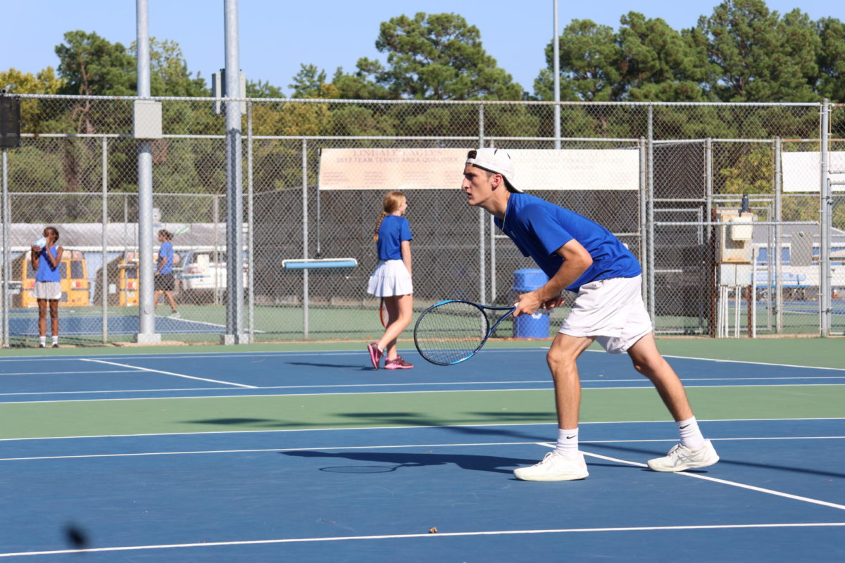 Tennis team member during a match. This was a boys singles match.