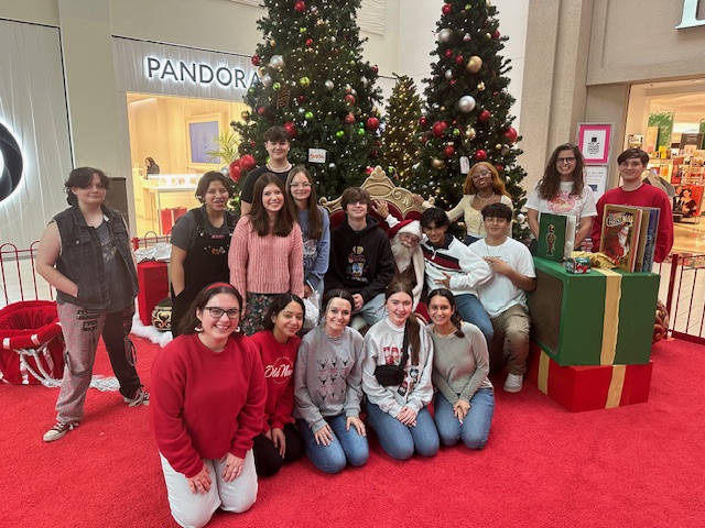 The fifth period law enforcement class poses with Santa. The students went to the mall and Walmart to shop for donations