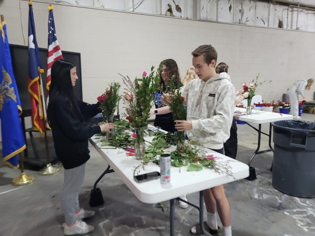 Students of the floral design class work on their projects in the ag shop. These flowers were sold to family and community members.