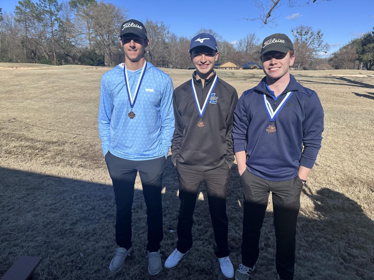 Senior Tobin Phillips and sophomores Seth Morrow and Jackson Pullin pose with their medals. They competed at Hideaway.
