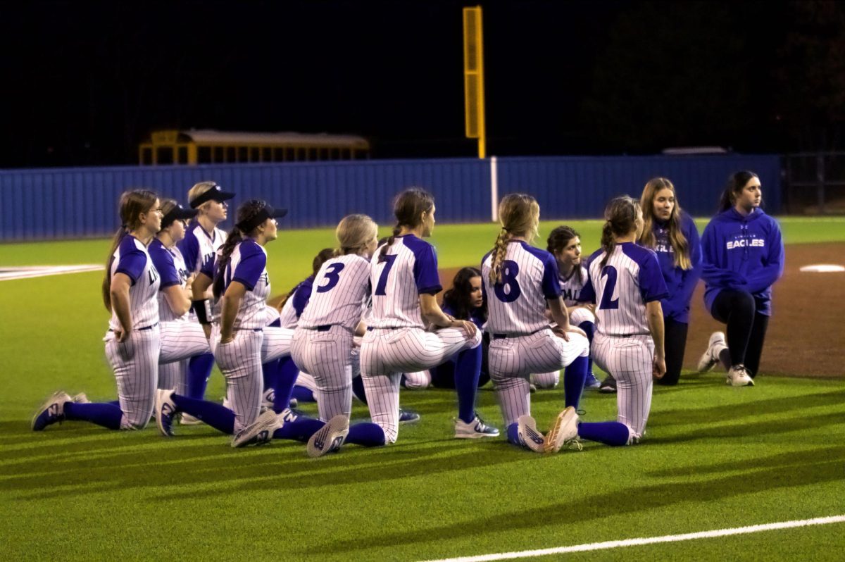 The Lindale Eagle Softball team huddles on the field. This was in the epilogue of a game.