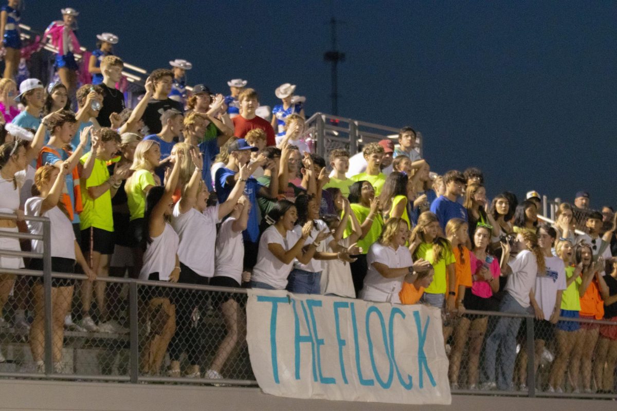 The Flock celebrates a successful run by the varsity football team. Senior students wear white and underclassman wear neon to fit the theme of the night. 