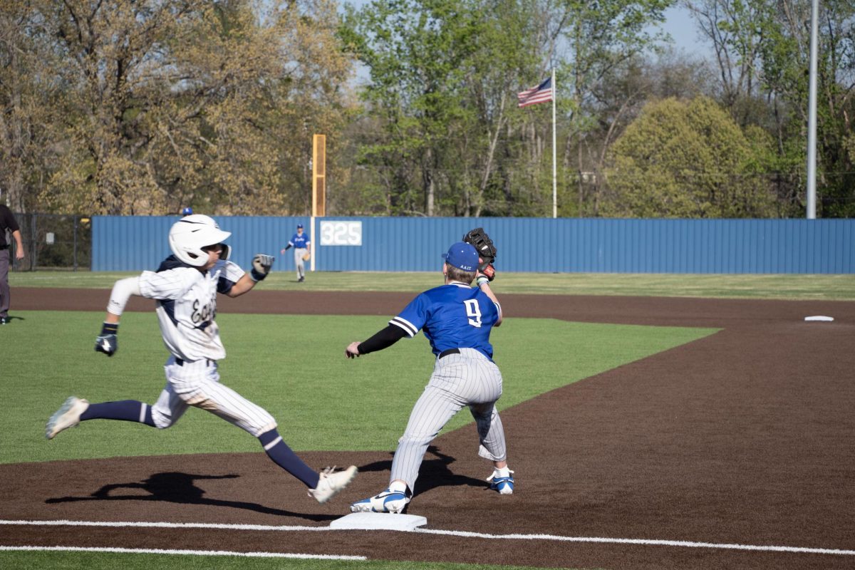 Freshman Jackson Legrow catches a ball and steals first base.