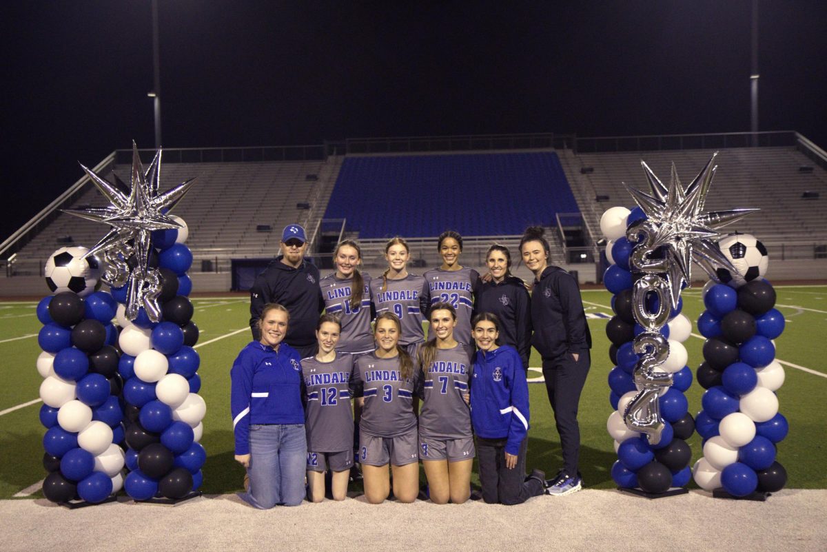 The seniors and coaches pose for a picture. The teams senior night was celebrated on March 20.
