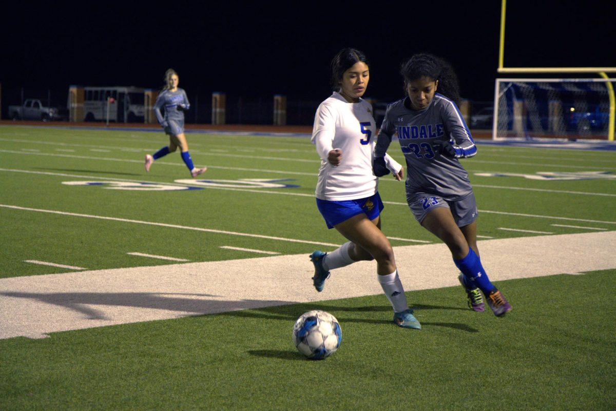 Junior Keyara Jenkins runs to steal the ball from her opponent. The team faced off against Chapel Hill.