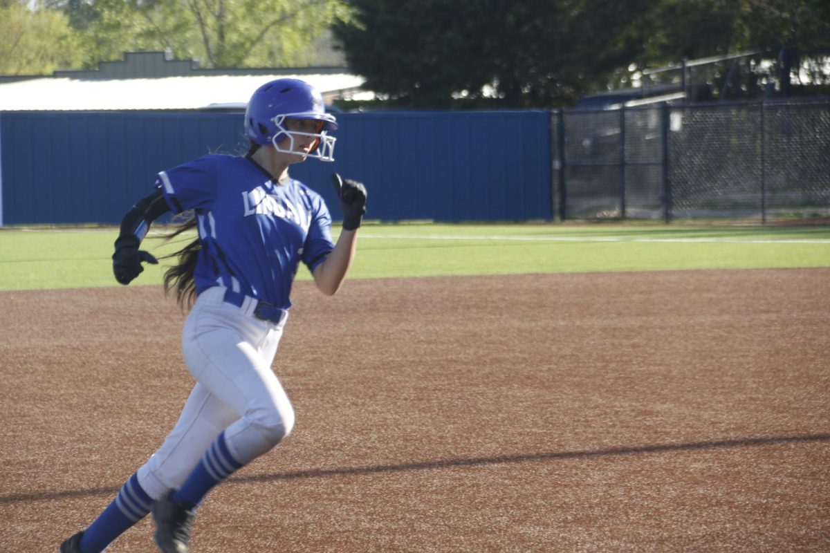 A softball player heads to home base at a recent JV softball game.