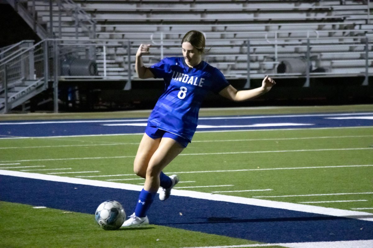 Freshman Emma Moore saves a ball from rolling out of bounds. The JV team played against Terrell in a non-district match.