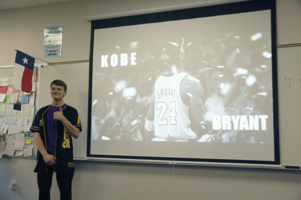 Sophomore Odin Burks poses in front of his presentation. He chose to research Kobe Bryant. 
