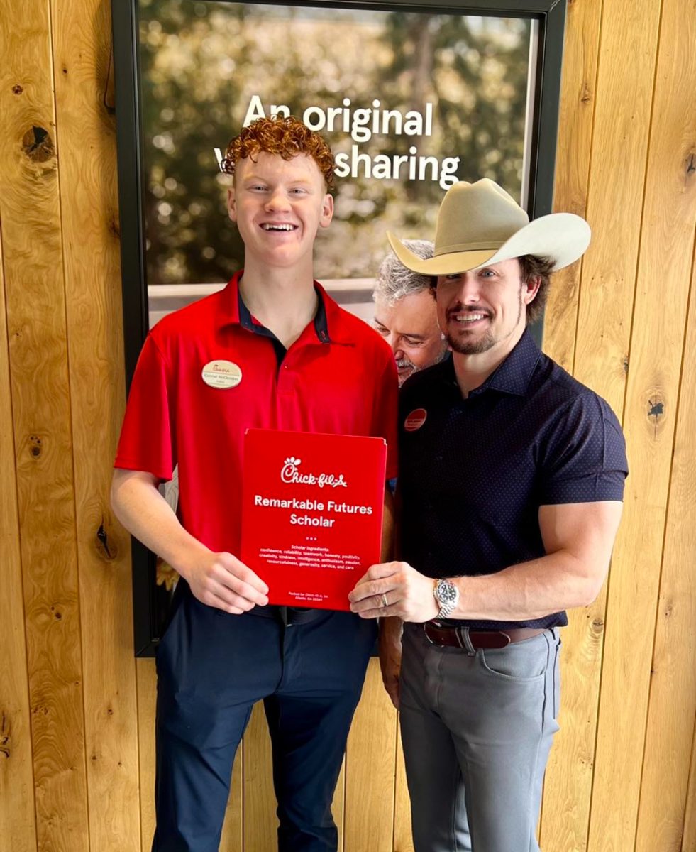 Senior Connor McClendon receives the Chick-fil-A Remarkable Future Scholarship from the owner, Joshua Johnson. He was one of the 16 total who was awarded it. 
Photo courtesy of Connor McClendon