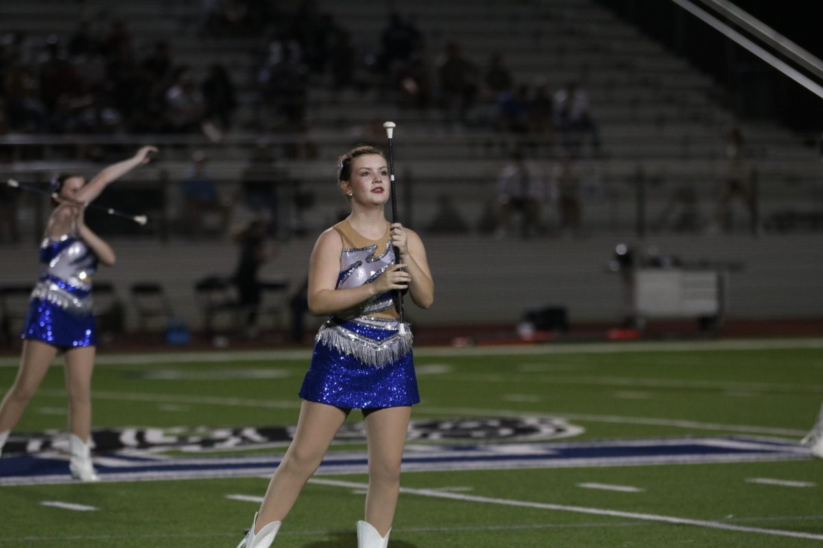 Sophomore Kylee Wilkinson poses during twirler routine. This was taken during a performance during an Eagle football game.