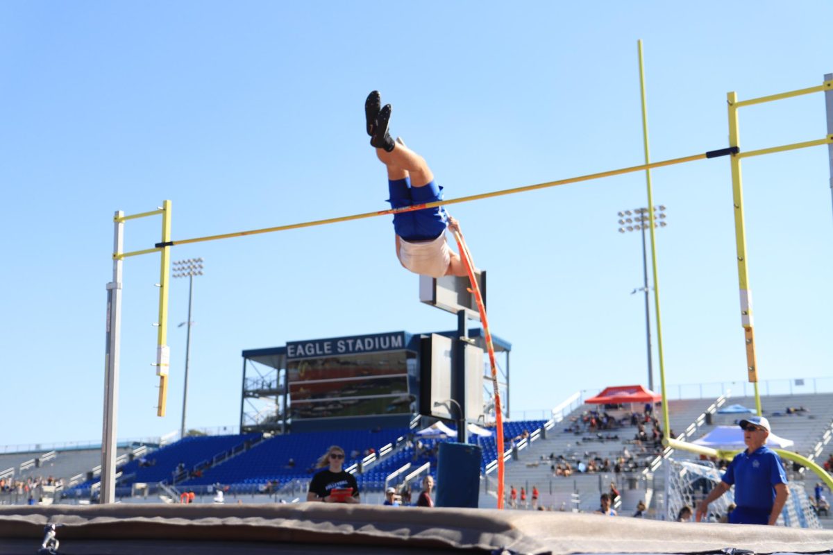 Student competing in pole vaulting. This  event requires students to vault themselves over a pole measured to a specific height. 