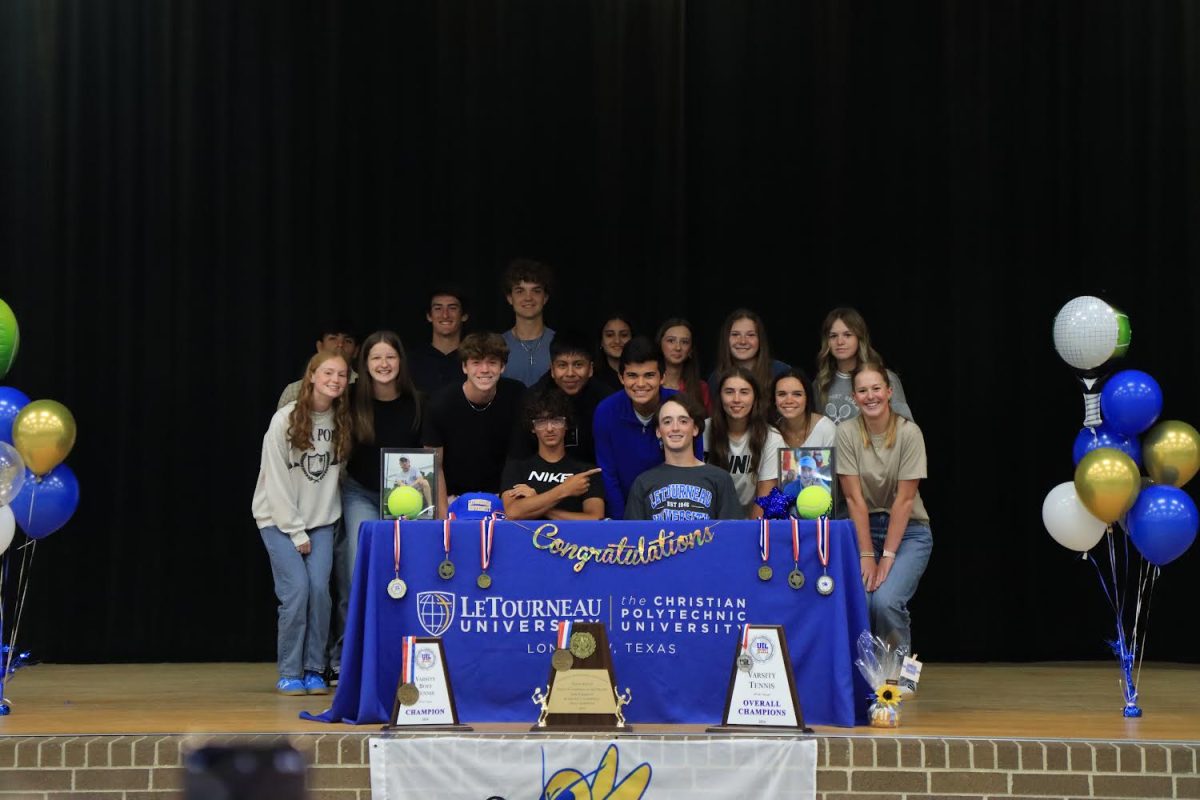 Hayden Harry takes a picture with his tennis team. “I’m so thankful for my team and coaches for always supporting me and encouraging me to push myself past what I thought was possible,” Harry said. 