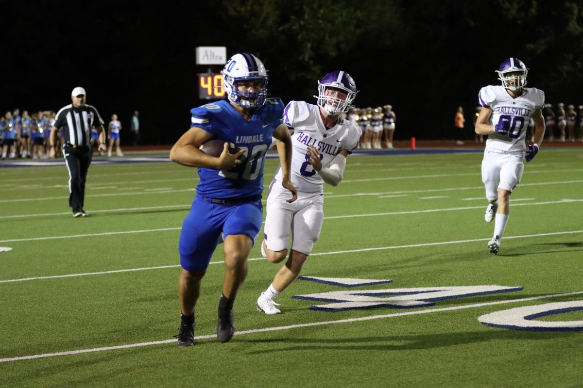 Senior Seth Baggett carries the ball towards the end zone. His played the position Kicker/Punter. 