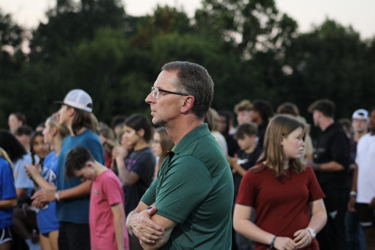 Teacher and speaker Duane Walton watches as Ella Hutchens gives her sermon. "I love students, and it's important to impact them spiritually," Walton said. "I want to help the next generation be godly."