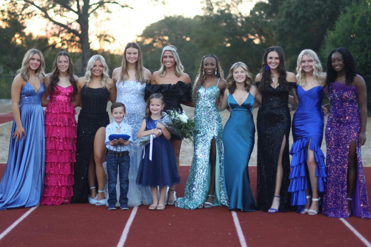 Homecoming court poses for a picture before the ceremony. 